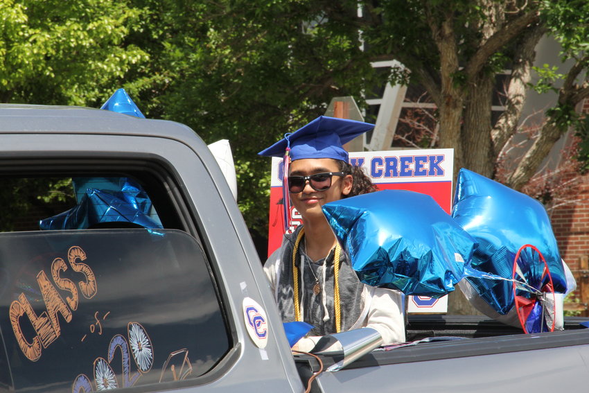 Student Ray Michael rides in a truck bed through the parade.